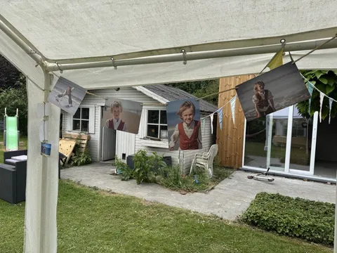 Photo panels hanging on a rope line at the garden party
