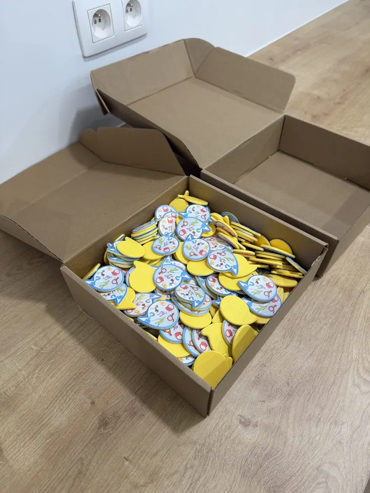 Cardboard boxes filled with printed yellow tokens